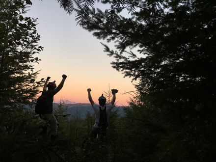 Local 528 Members watching the sunrise after making it to the top of the mountain with headlamps.