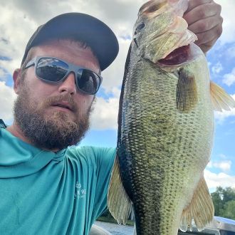Nick LaBombard, Local 534 Boston, with a small mouth bass during the Mass. State Fishoffs.